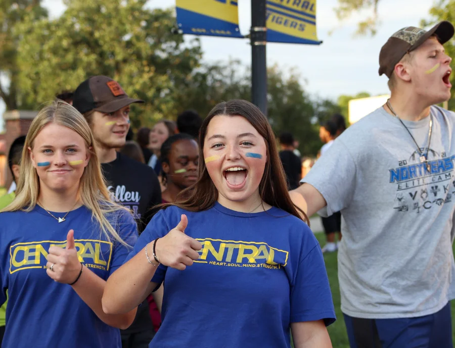 Central Christian College of Kansas students wearing school colors and cheering together on campus, reflecting school spirit and student community.