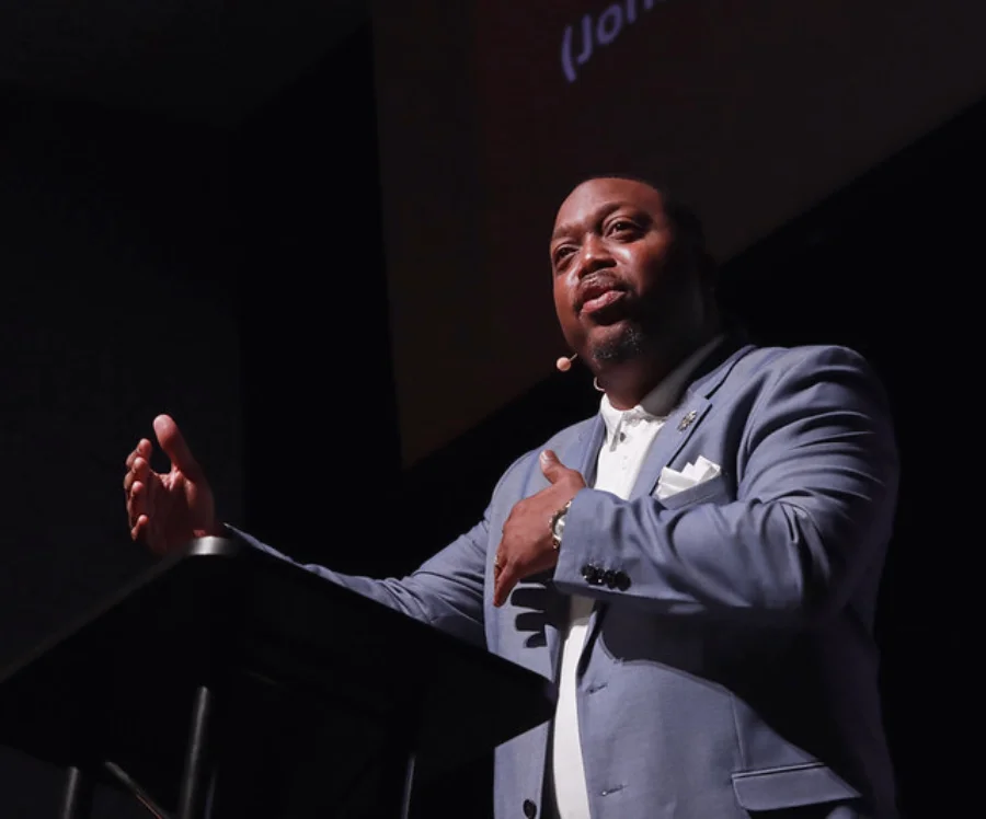 Speaker addressing an audience from a stage at Central Christian College of Kansas, reflecting leadership, inspiration, and campus engagement.