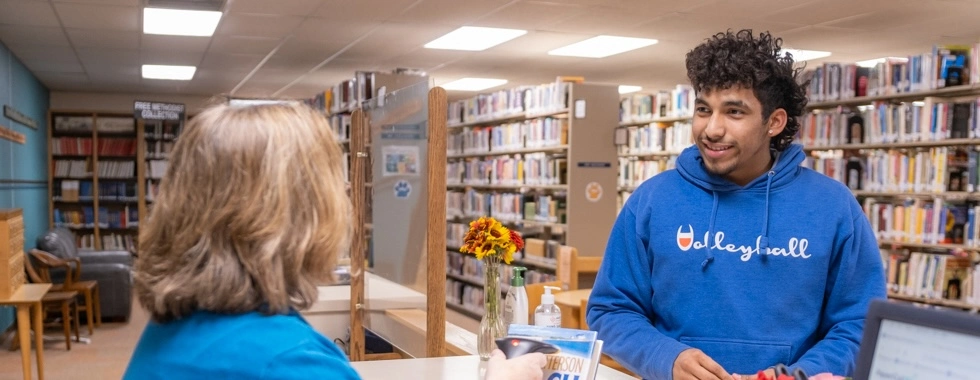 Student receiving assistance from staff at the Briner Academic Center, highlighting academic resources and personalized student support.