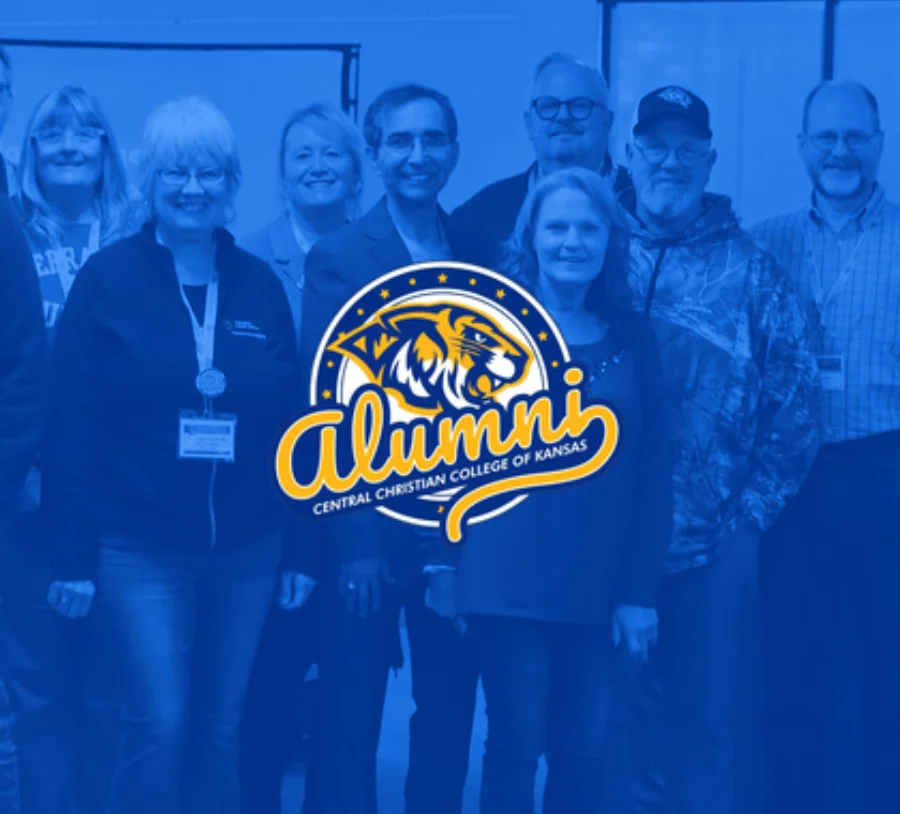 Group of alumni standing together at a Christian College event, featuring the Central Christian College of Kansas alumni logo and celebrating lifelong community.