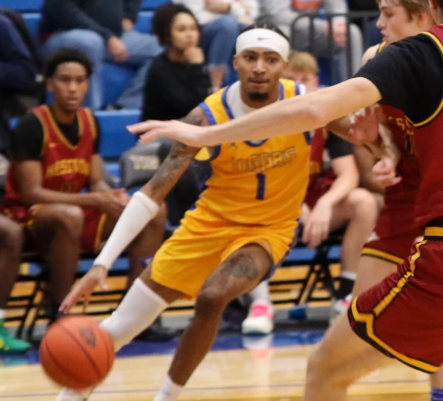 Student-athlete driving the ball during a competitive basketball game at a Christian College, showcasing athletic excellence, teamwork, and school spirit.